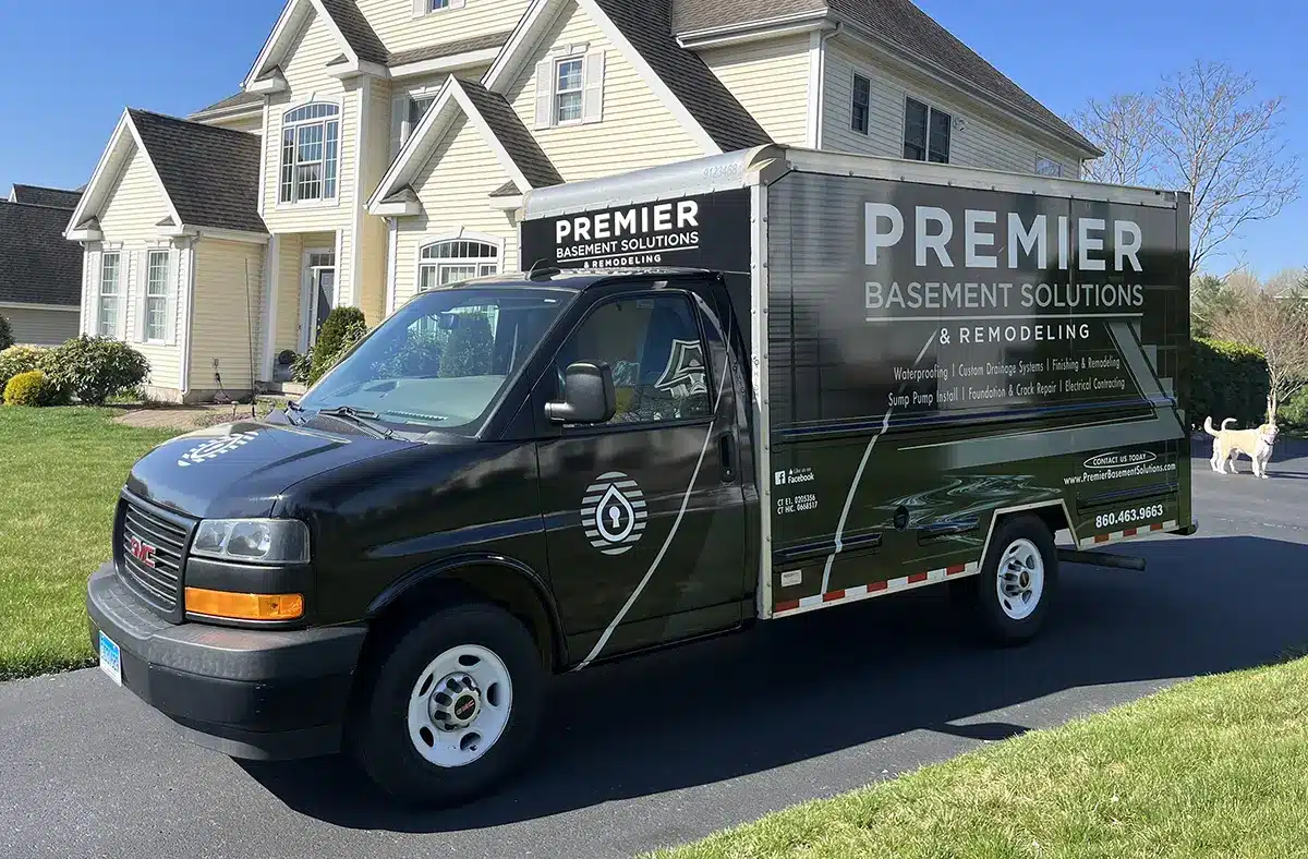 premier-basement-solutions-remodeling Premier Basement Solutions & Remodeling van parked in front of a Connecticut home, showcasing professional basement waterproofing and remodeling services in Rocky Hill, CT.